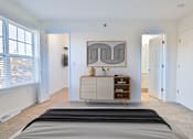 Thumbnail 15 of 102 - A bedroom with a large bed and a painting on the wall.
