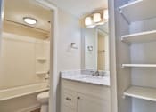 Thumbnail 44 of 47 - A white bathroom with a toilet, sink, and mirror.