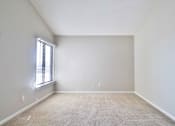 Thumbnail 45 of 47 - A room with a window and carpeted floor.