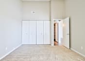 Thumbnail 47 of 47 - A room with a carpeted floor and a white door.