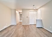 Thumbnail 31 of 39 - A room with wood flooring and white walls.