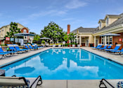 Thumbnail 1 of 93 - A large swimming pool with lounge chairs and umbrellas.