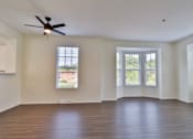 Thumbnail 89 of 102 - A room with a ceiling fan and three windows.