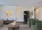 Thumbnail 7 of 93 - A living room with a brown coffee table and green chairs.