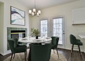 Thumbnail 8 of 93 - A dining room with a white table and green chairs.