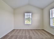 Thumbnail 94 of 102 - A room with a carpeted floor and a window with blinds.