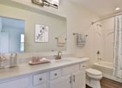 Thumbnail 13 of 93 - A white bathroom with a sink, toilet, and bathtub.