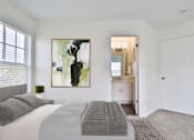 Thumbnail 16 of 93 - A bedroom with a large bed and a painting on the wall.