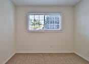 Thumbnail 32 of 33 - A room with a window and a carpeted floor.