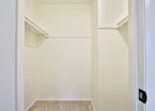 Thumbnail 31 of 33 - A white hallway with a door on the right.