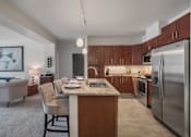 Thumbnail 17 of 31 - A modern kitchen with a refrigerator, oven, and sink.