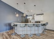 Thumbnail 9 of 43 - a kitchen with an island and stools