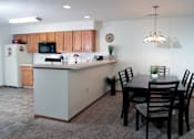 Thumbnail 18 of 44 - A kitchen with a dining table and chairs.