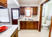 Thumbnail 11 of 27 - a full view of a kitchen with a toilet and sink