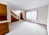Thumbnail 15 of 27 - an empty living room with a large window and a staircase