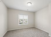 Thumbnail 6 of 12 - A room with a window and a carpeted floor.