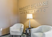 Thumbnail 46 of 75 - two chairs and a lamp in a room with a sign that says market square apartments