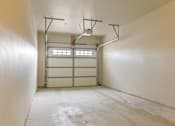 Thumbnail 45 of 75 - an empty room with white walls and a garage door