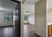 Thumbnail 22 of 44 - an empty living room with wooden floors and a black door