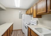 Thumbnail 16 of 44 - an empty kitchen with a stove refrigerator and sink