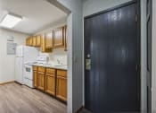 Thumbnail 17 of 44 - a kitchen with wooden cabinets and white appliances and a black door