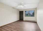 Thumbnail 19 of 44 - an empty living room with wood flooring and a window