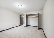Thumbnail 9 of 44 - a empty room with white walls and a door to a closet