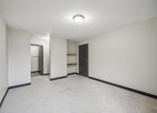Thumbnail 10 of 44 - a empty room with white walls and a door to a closet