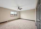 Thumbnail 42 of 44 - an empty living room with a ceiling fan and a window
