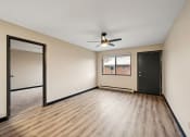 Thumbnail 34 of 44 - an empty living room with wood flooring and a ceiling fan