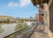 Thumbnail 7 of 35 - the view of the river from the balcony of a building with a balcony railing