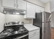 Thumbnail 3 of 21 - an empty kitchen with stainless steel appliances and white cabinets
