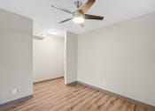 Thumbnail 18 of 21 - the living room of an empty house with a ceiling fan