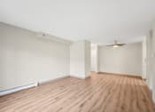 Thumbnail 10 of 21 - a living room with a hard wood floor and white walls