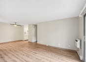 Thumbnail 16 of 21 - the living room of an apartment with wood flooring and a large window