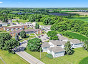 Thumbnail 13 of 52 - A bird's eye view of a residential area with houses and greenery.