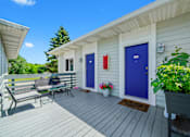Thumbnail 10 of 52 - A small house with a blue door and a red door.