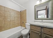 Thumbnail 47 of 52 - A bathroom with a white tub, toilet, and sink.