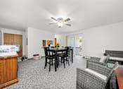 Thumbnail 26 of 52 - A living room with a dining table and chairs.