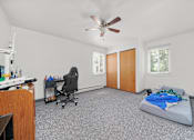 Thumbnail 42 of 52 - A room with a bed, desk, and chair.