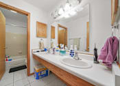 Thumbnail 50 of 52 - A bathroom with a white sink and a mirror above it.