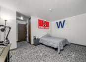 Thumbnail 46 of 52 - A bedroom with a bed, dresser, and a sign on the wall.