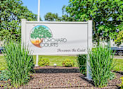 Thumbnail 16 of 52 - A sign for Yorchard Courts with a tree on it.