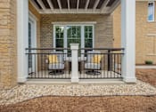 Thumbnail 12 of 31 - A patio with a table and chairs is surrounded by a white railing.