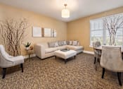 Thumbnail 9 of 31 - A living room with a couch, chair, and table.
