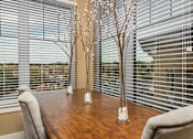Thumbnail 8 of 31 - A dining room with a wooden table and chairs.