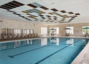 Thumbnail 12 of 43 - A large indoor swimming pool with a mosaic ceiling.