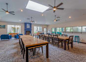 Thumbnail 15 of 43 - A large room with tables and chairs and a ceiling fan.