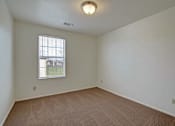 Thumbnail 31 of 48 - A room with a carpeted floor and a window with blinds.