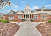 Thumbnail 1 of 48 - A large brick building with a central entrance and a symmetrical design.